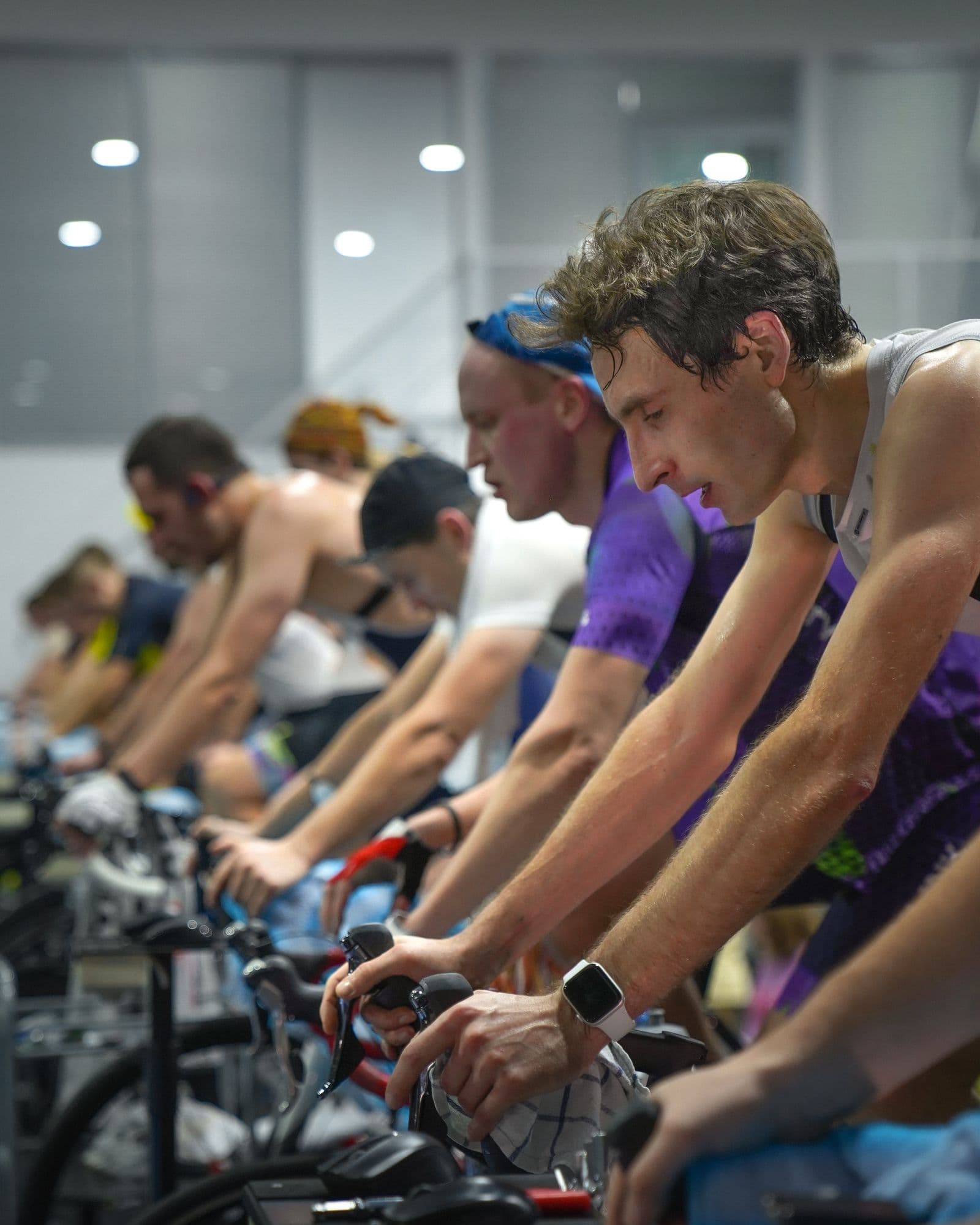 Dark, moody indoor cycling studio at Body by Alison Caroline